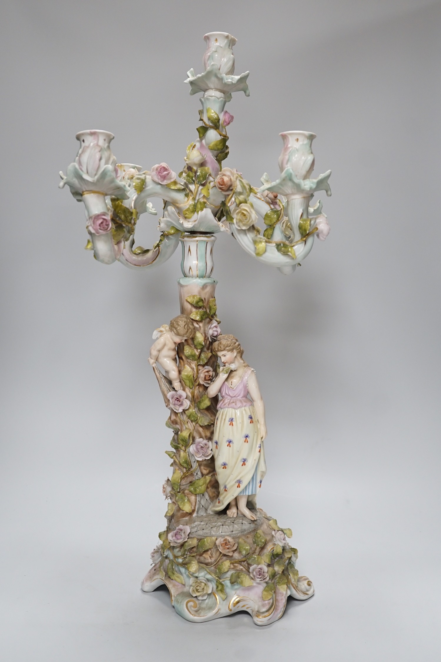 A Sitzendorf-style floral encrusted 4 branch candelabra, 57cms high